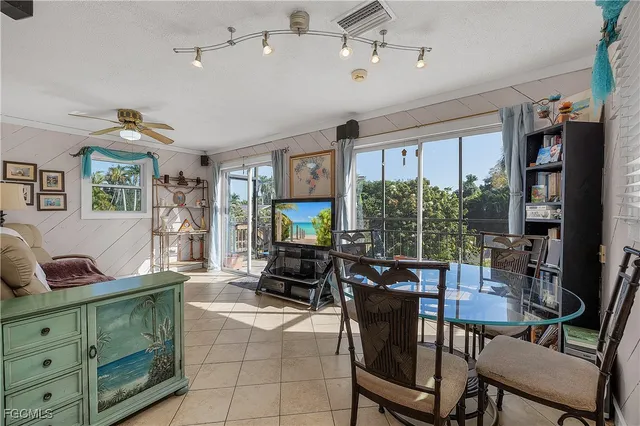 a living room with furniture a flat screen tv and a large window