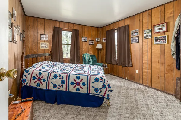 a bed sitting in a bedroom next to a window