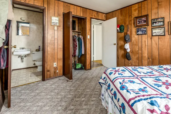 a bedroom with a bed and a mirror