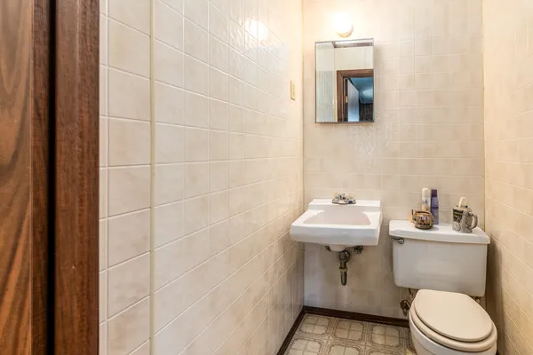 a bathroom with a sink toilet and mirror