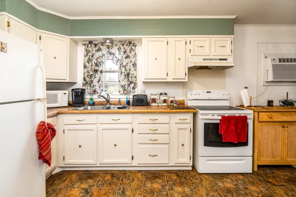 a kitchen with stainless steel appliances granite countertop a sink and a stove
