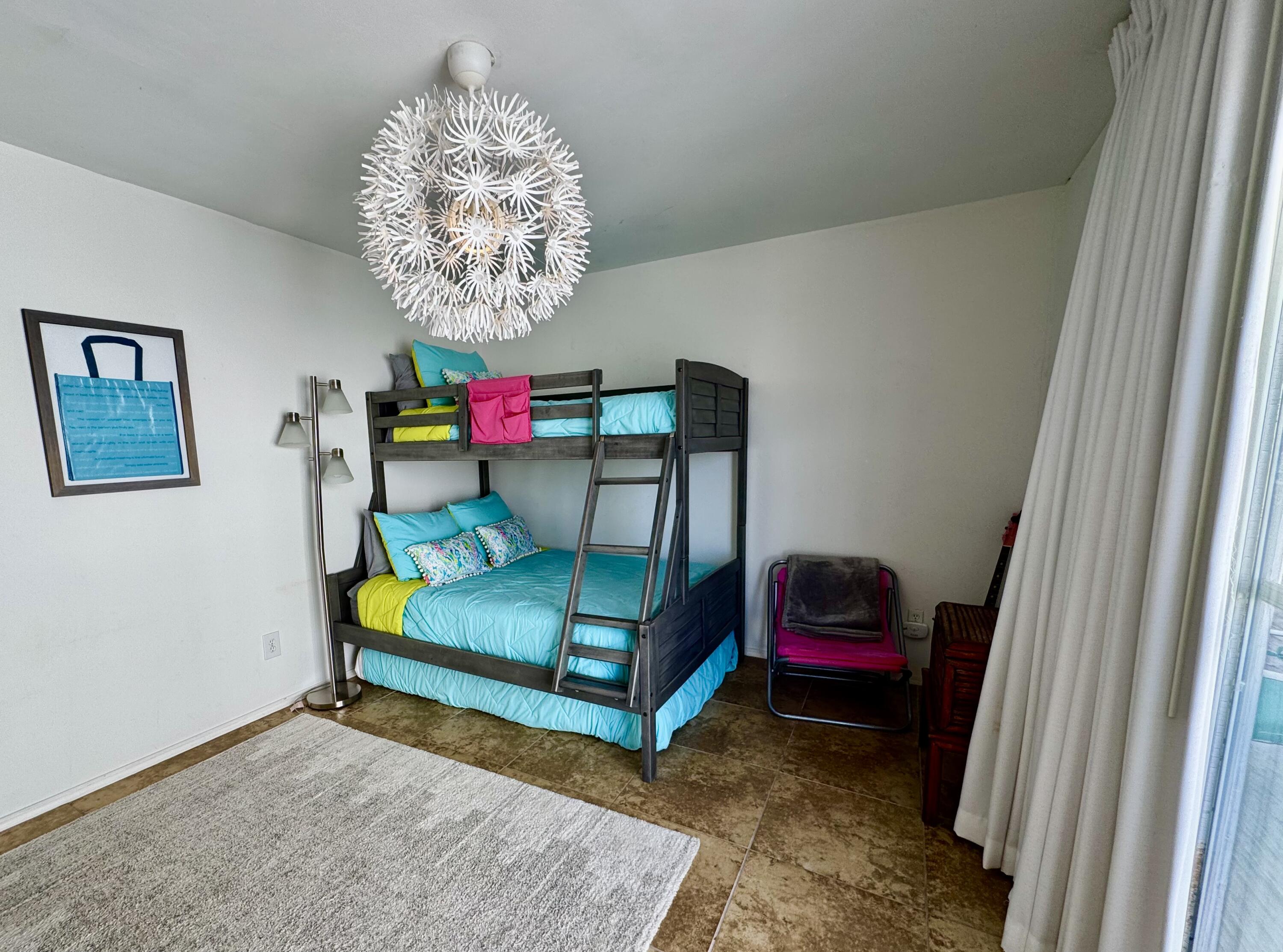 228 Walton Magnolia Lane, Unit 9 Inlet Beach, FL 32461 - Photo 17 of 24 a bedroom with a bed and a chandelier