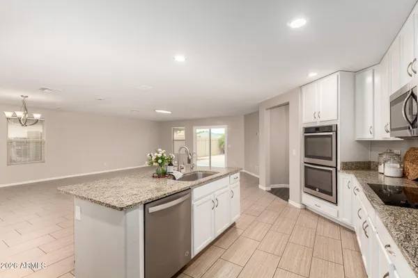 a view of kitchen with refrigerator microwave and cabinets