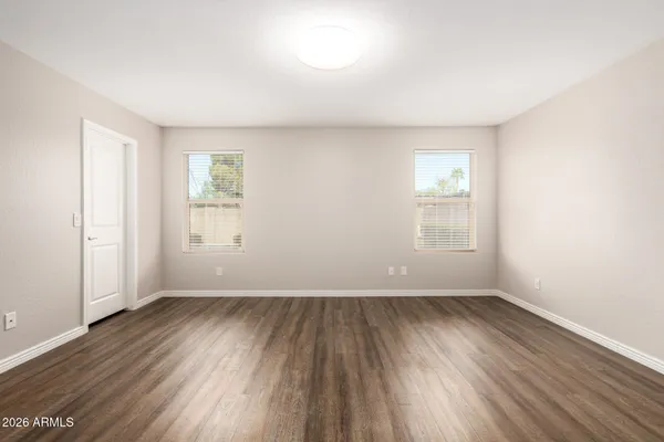 a kitchen with stainless steel appliances granite countertop a sink a stove a refrigerator a microwave cabinets and wooden floor