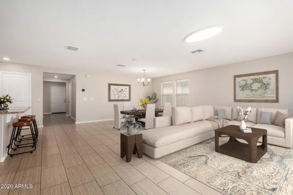 an empty room with potted plants and wooden floor