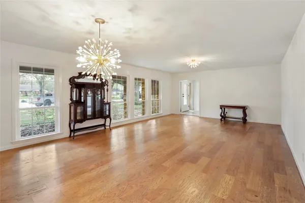 a hallway with cabinets and wooden floor