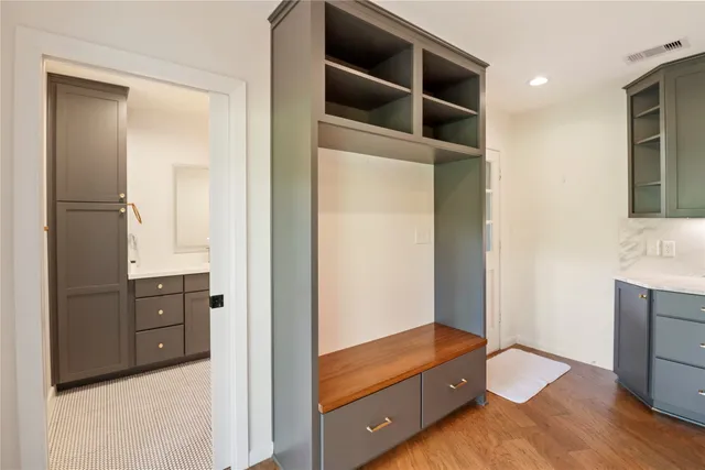 a kitchen with a sink cabinets and wooden floor