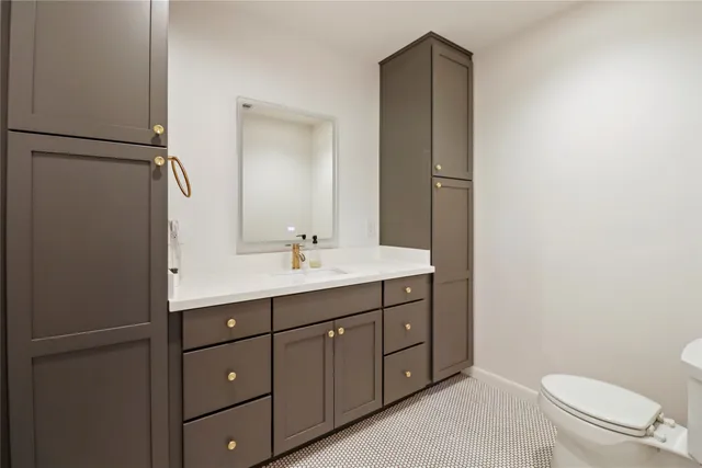 an empty room with wooden floor and fan
