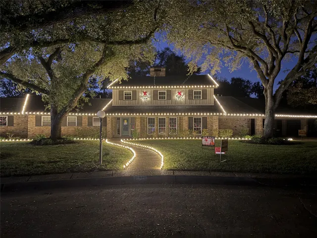 a front view of a house with swimming pool and furniture