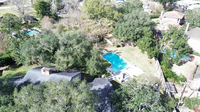 an aerial view of a house with yard swimming pool and outdoor seating