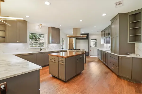 a kitchen with stainless steel appliances granite countertop a stove and a sink