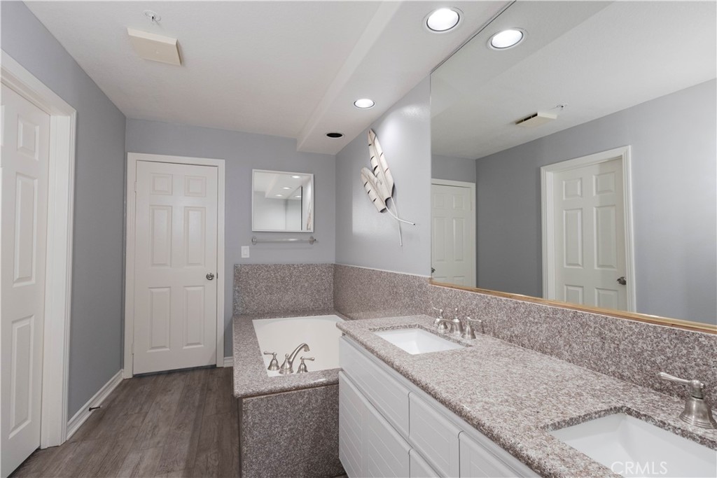 2233 Martin, Unit 108 Irvine, CA 92612 - Photo 12 of 31 a bathroom with a granite countertop sink and mirror