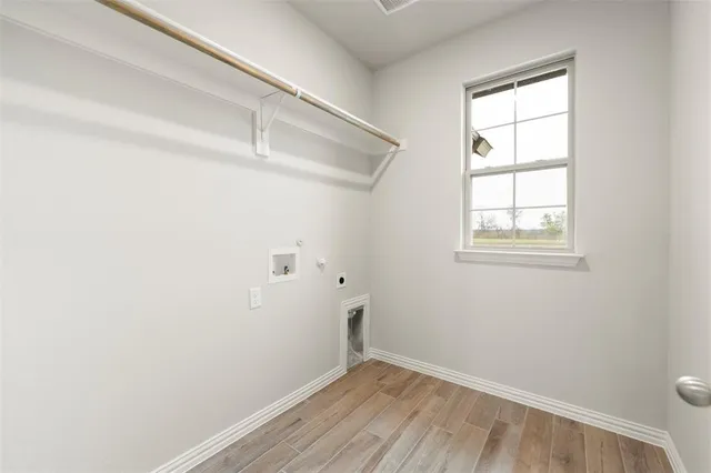 a kitchen with a sink cabinets and wooden floor