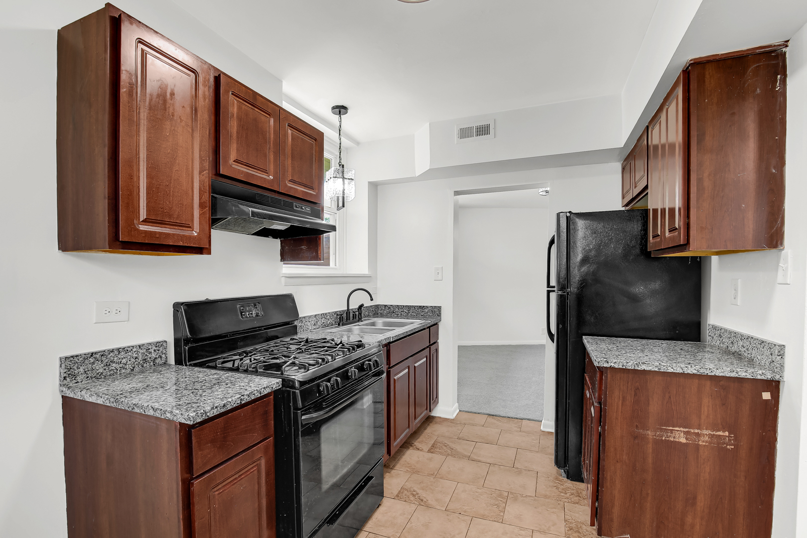 18548 Lyn Court Homewood, IL 60430 - Photo 5 of 16 a kitchen with stainless steel appliances granite countertop a stove a refrigerator and a microwave
