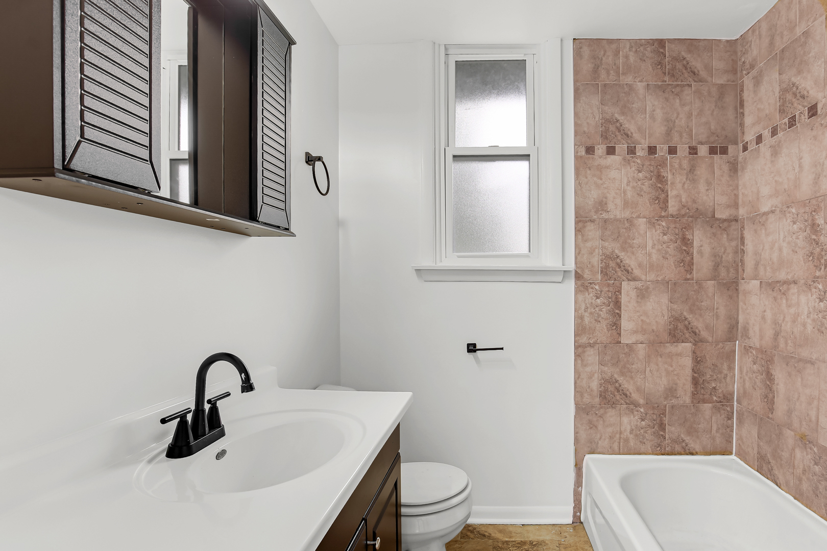 18548 Lyn Court Homewood, IL 60430 - Photo 6 of 16 a bathroom with a sink a toilet and shower