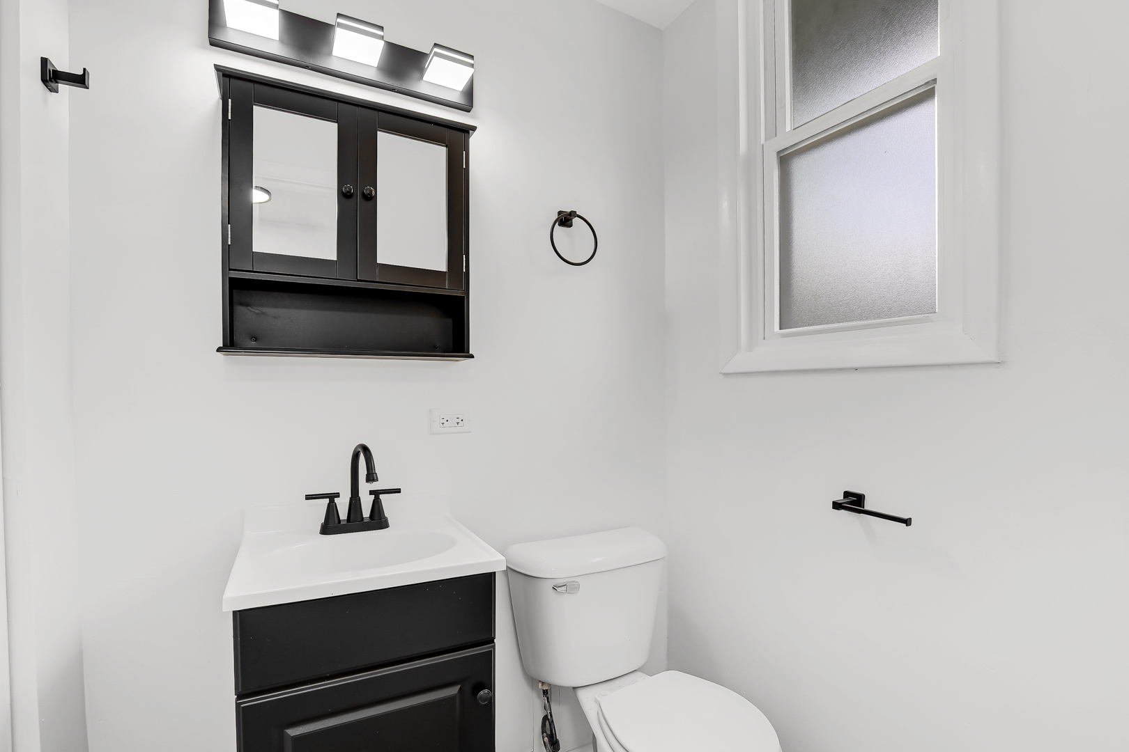 18548 Lyn Court Homewood, IL 60430 - Photo 9 of 16 a bathroom with a toilet a sink and mirror