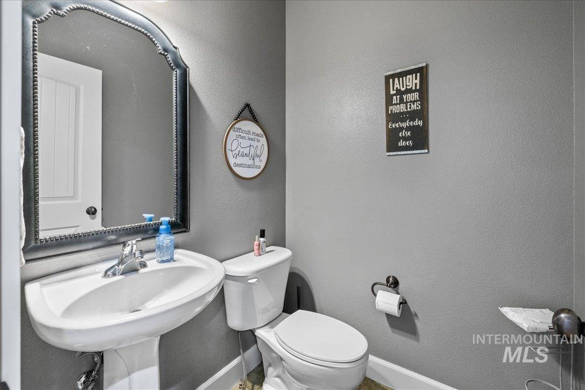 1063 West Hitchcock Street Meridian, ID 83646 - Photo 18 of 50 Half bath featuring a textured wall and baseboards