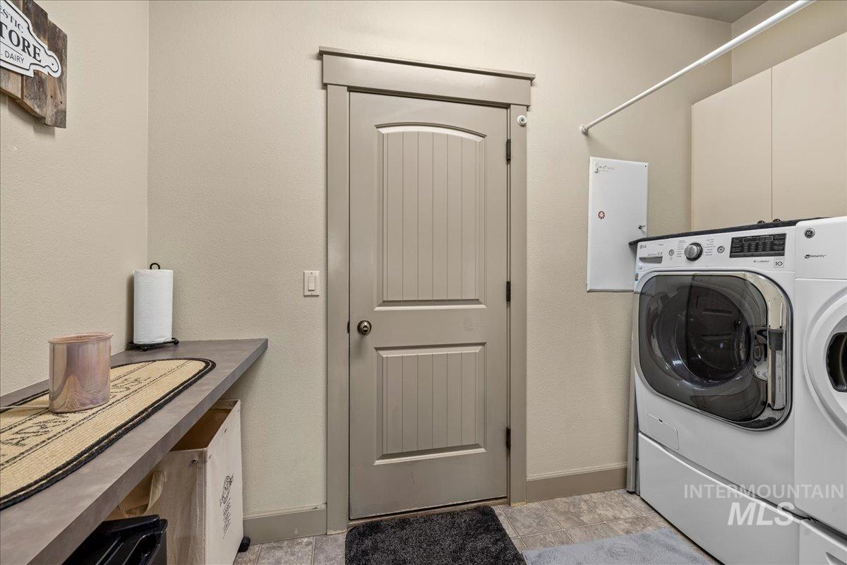1063 West Hitchcock Street Meridian, ID 83646 - Photo 19 of 50 Laundry room featuring separate washer and dryer and cabinet space