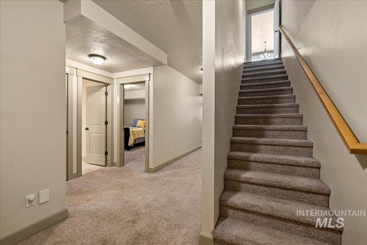 1063 West Hitchcock Street Meridian, ID 83646 - Photo 25 of 50 Stairs with carpet and a textured ceiling