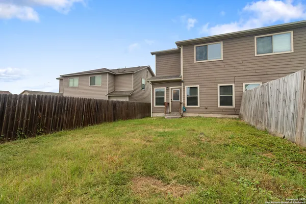 a view of a house with wooden fence