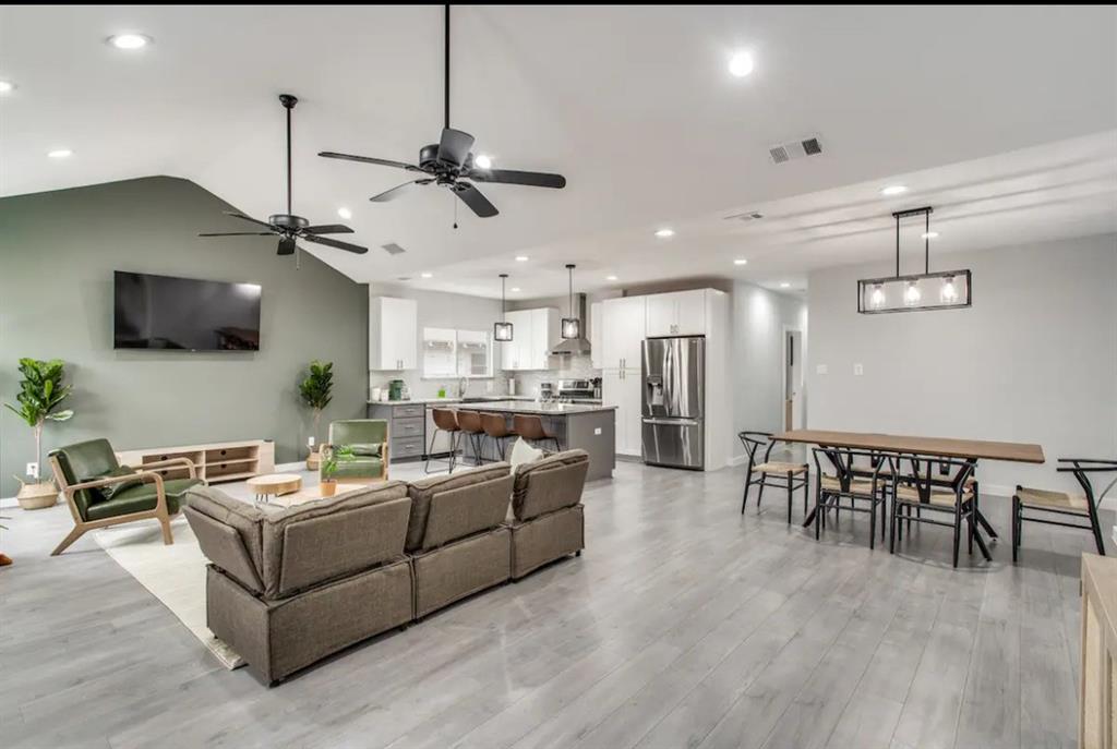 1606 West 12th Street Dallas, TX 75208 - Photo 5 of 20 Living room featuring light wood finished floors, ceiling fan, vaulted ceiling, and recessed lighting