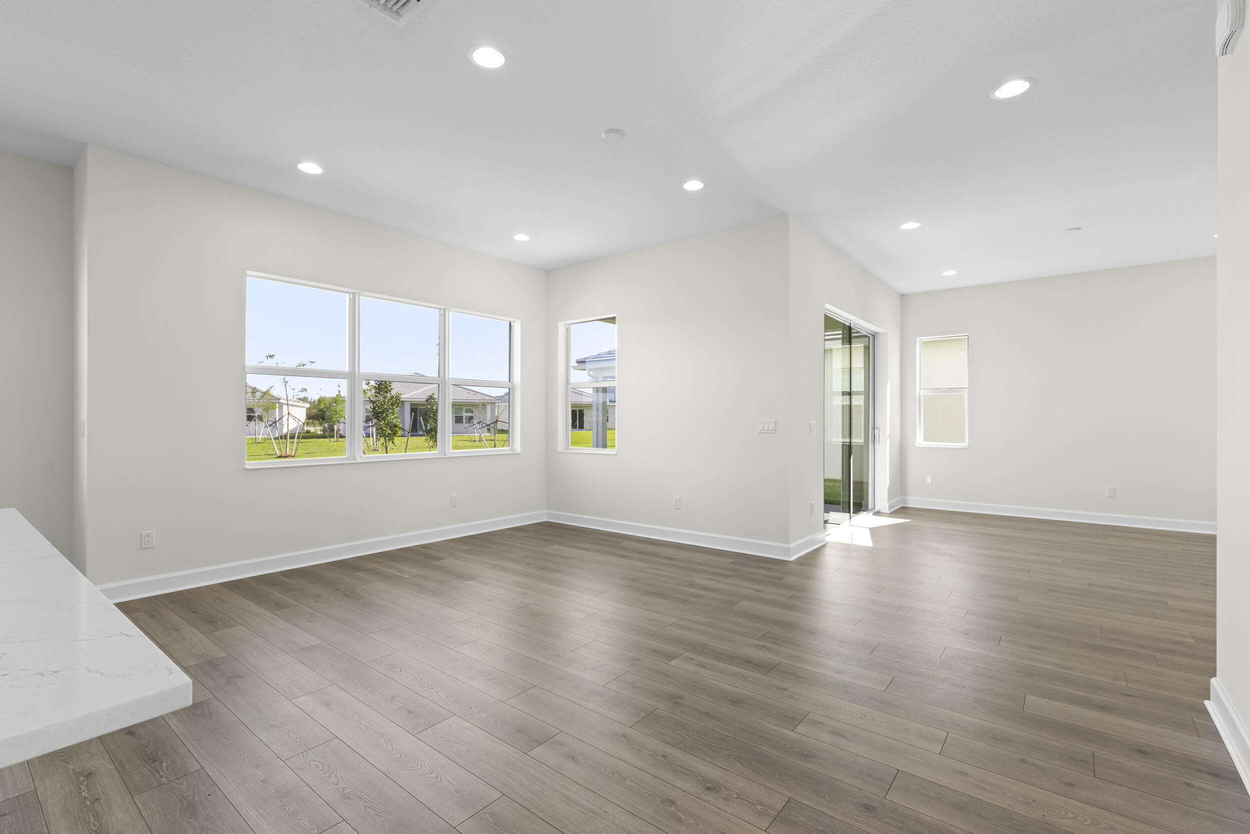 14159 Gray Bark Bend Westlake, FL 33470 - Photo 15 of 87 an empty room with wooden floor and windows
