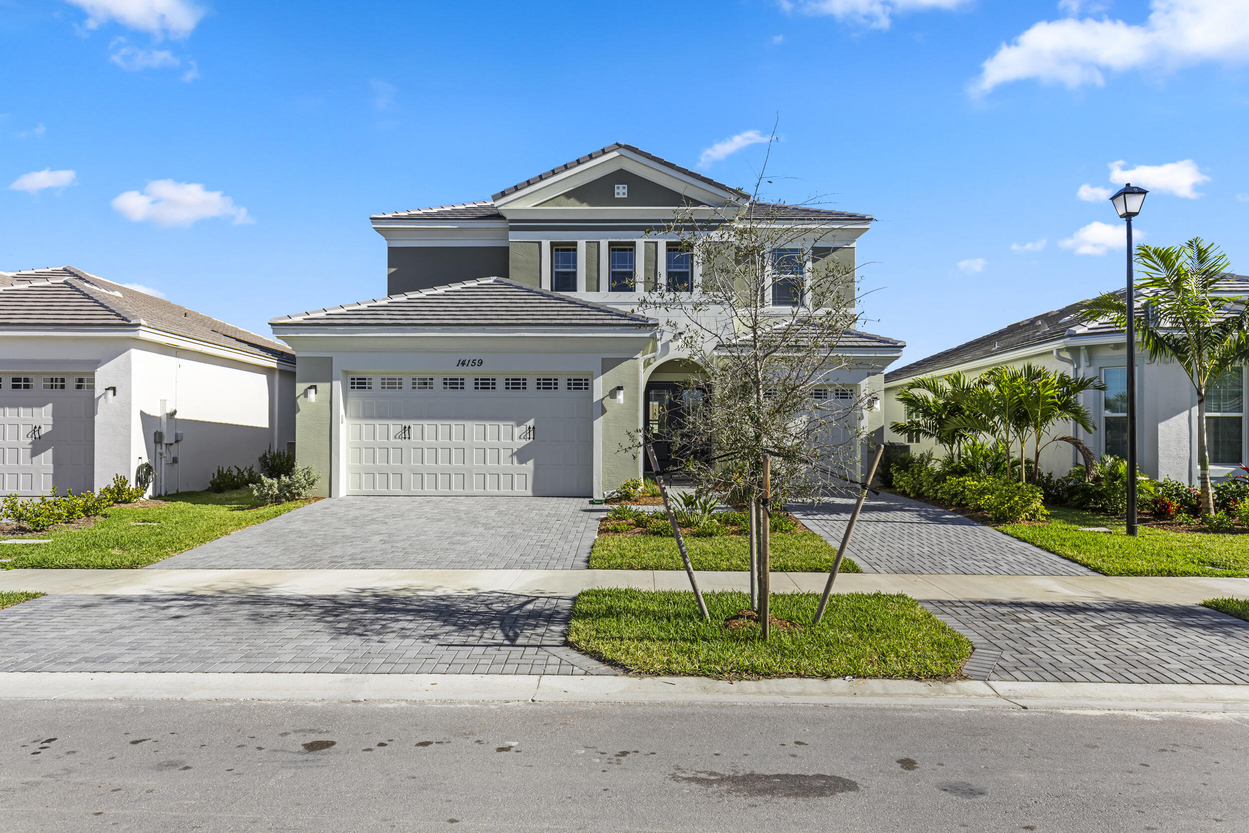 14159 Gray Bark Bend Westlake, FL 33470 - Photo 2 of 87 a front view of a house with a yard and garage