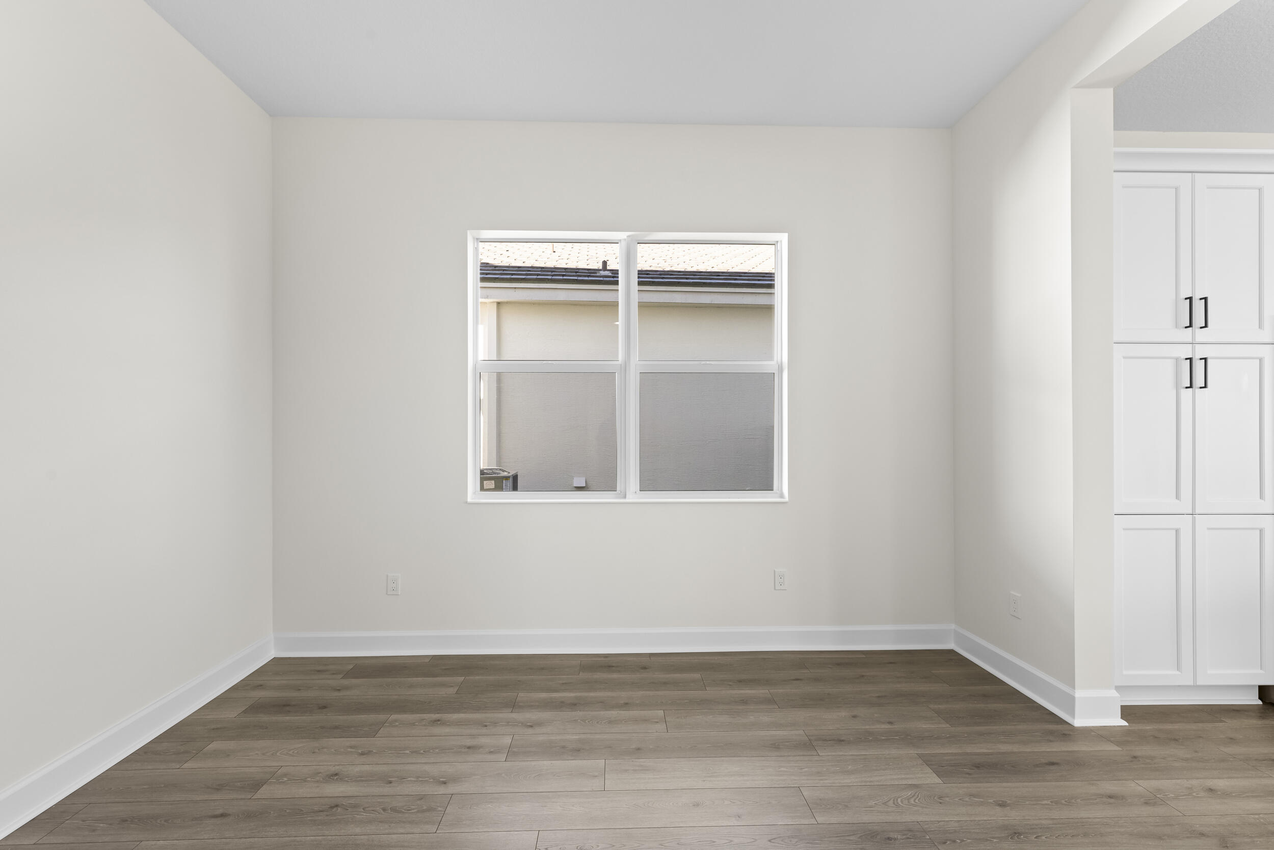 14159 Gray Bark Bend Westlake, FL 33470 - Photo 22 of 87 a view of an empty room with wooden floor and a window
