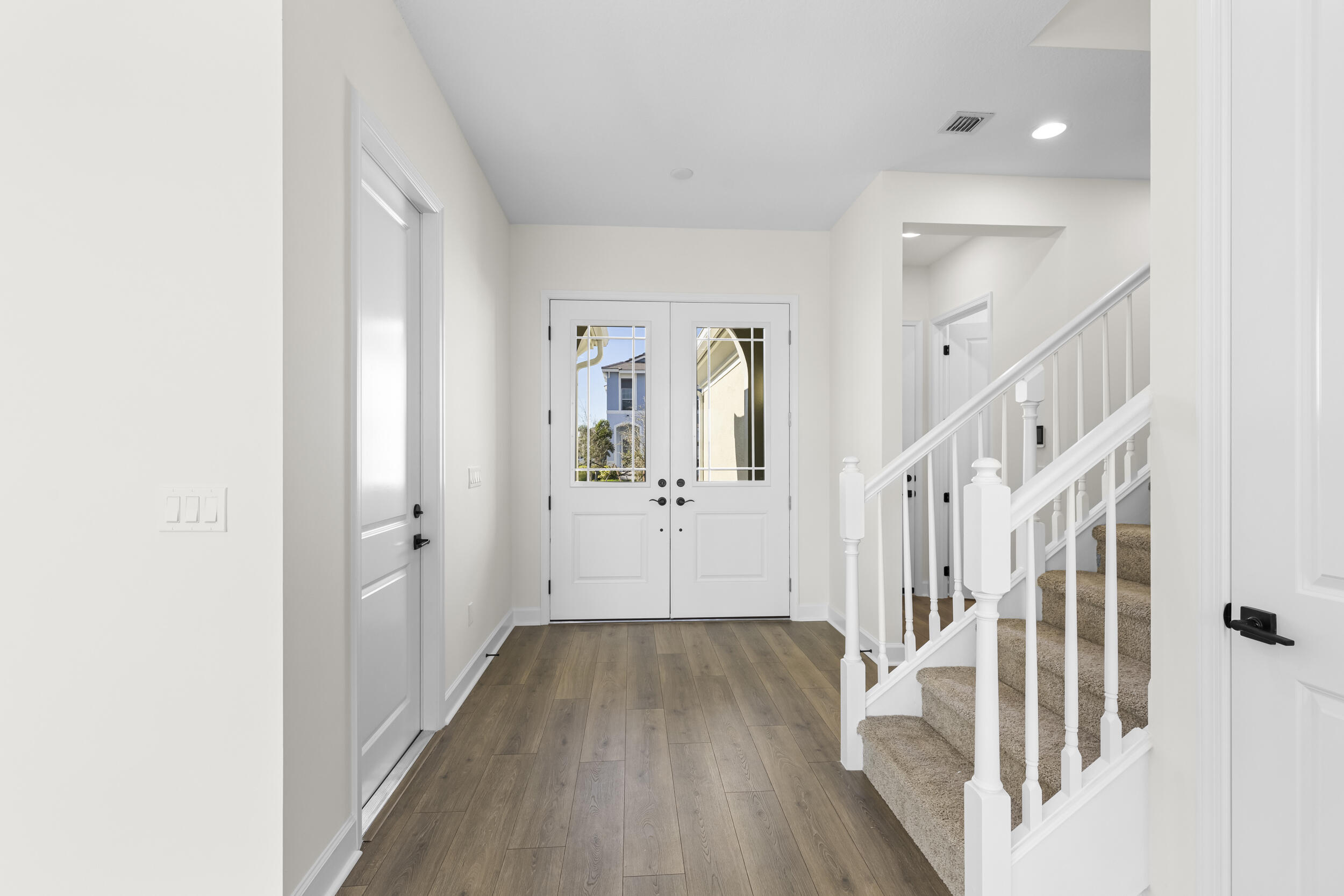 14159 Gray Bark Bend Westlake, FL 33470 - Photo 8 of 87 a view of a hallway with wooden floor and staircase