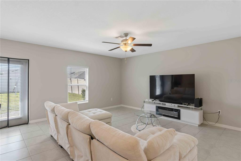 9440 Lemon Drop Loop Sun City Center, FL 33573 - Photo 20 of 55 a living room with furniture and a flat screen tv