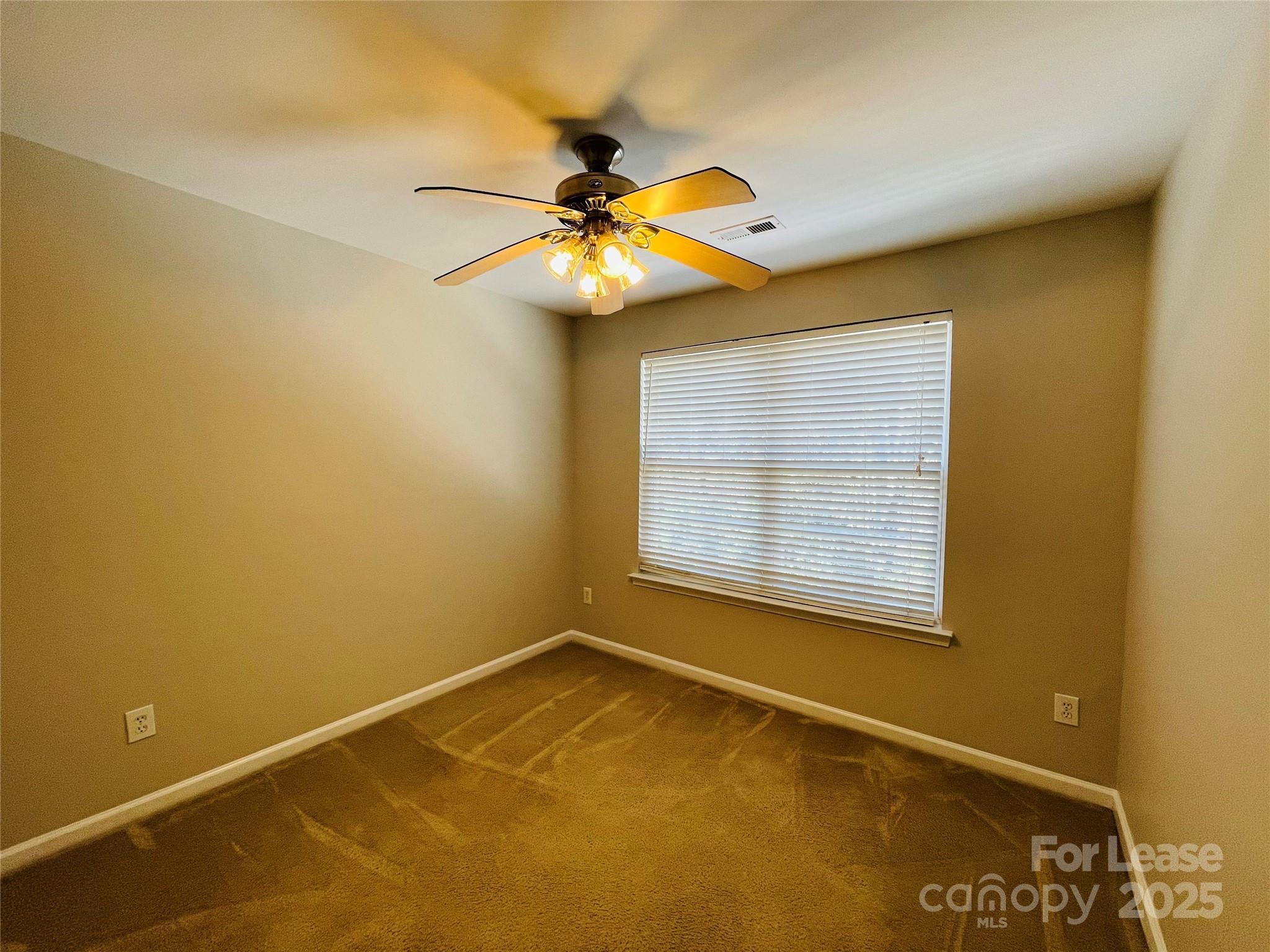 724 Shellstone Place Fort Mill, SC 29708 - Photo 11 of 17 a view of an empty room with window and chandelier fan
