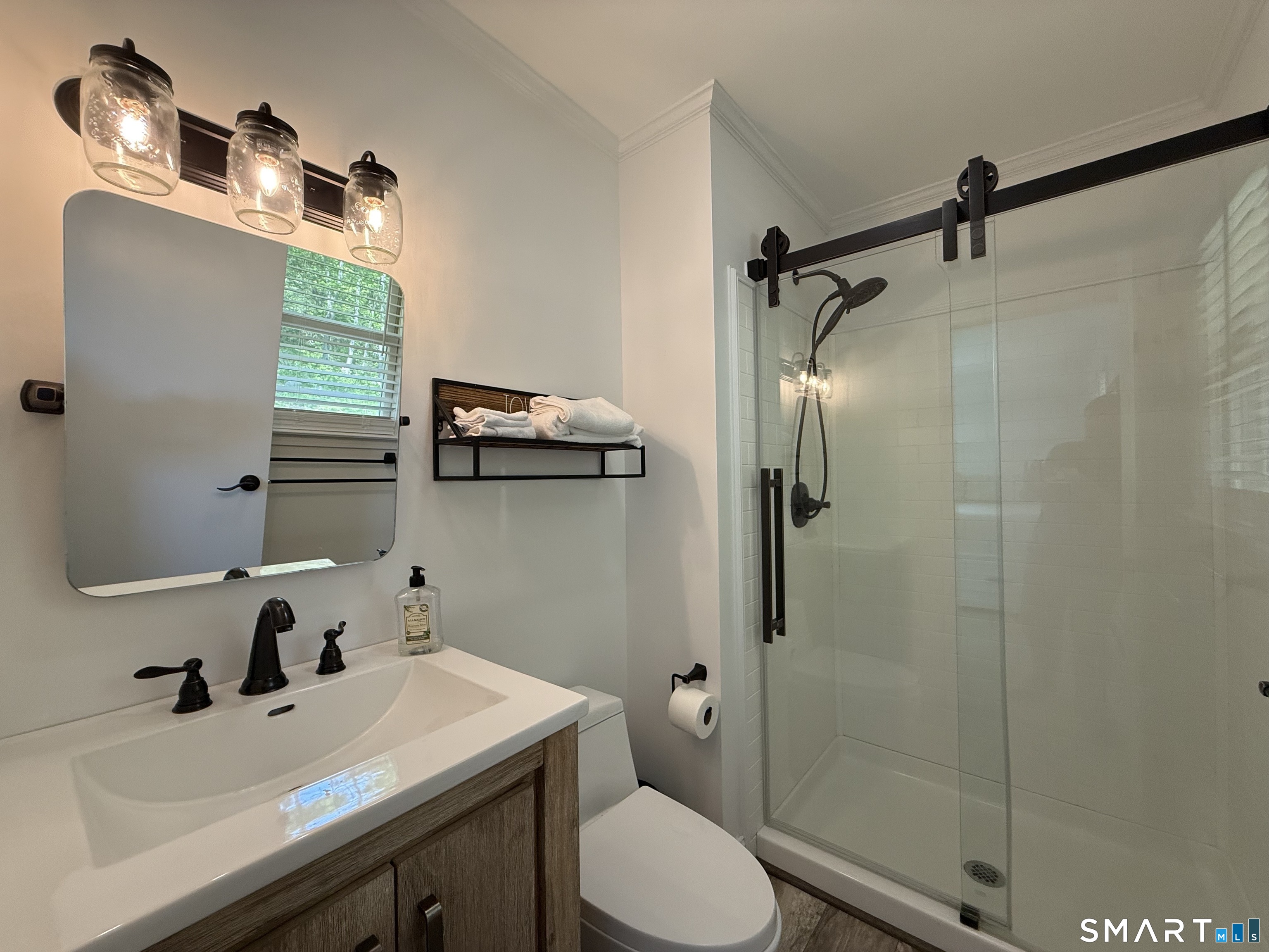 29 Deer Ridge Road Stonington, CT 06378 - Photo 25 of 35 a bathroom with a sink toilet and shower