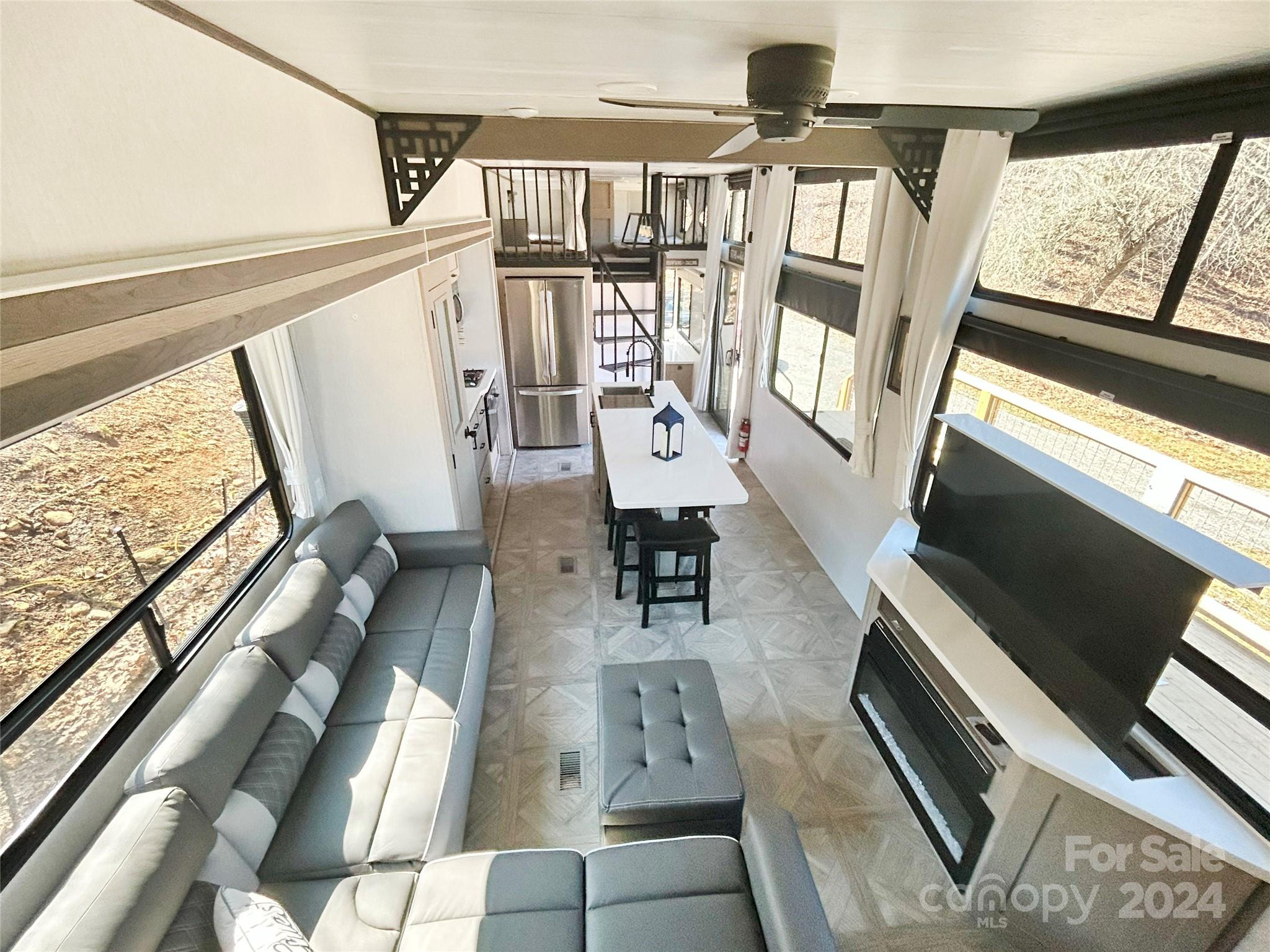 3280 Laurel Valley Road Mars Hill, NC 28754 - Photo 11 of 21 a living room with furniture and a floor to ceiling window