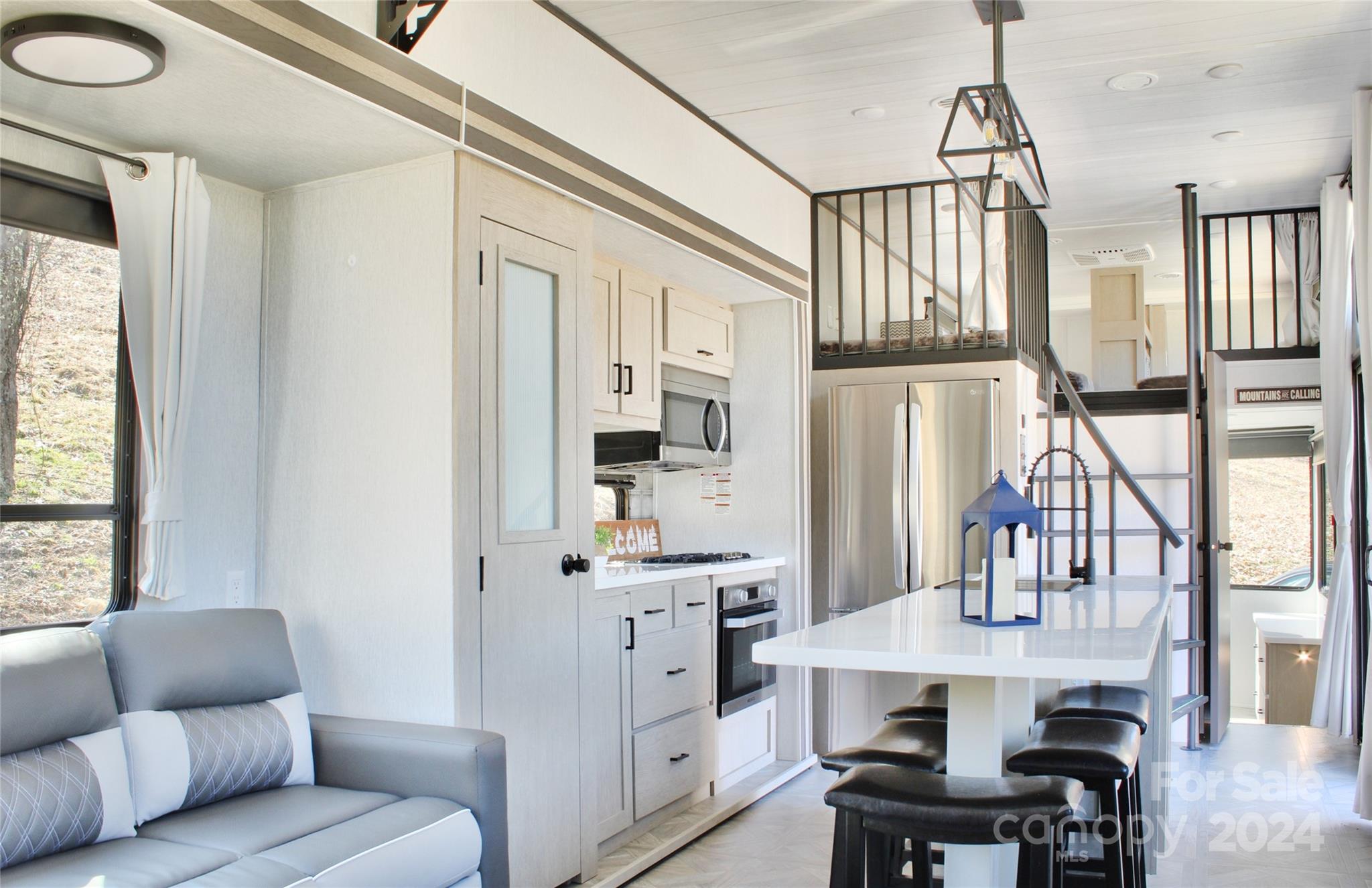 3280 Laurel Valley Road Mars Hill, NC 28754 - Photo 4 of 21 a living room with furniture a dining table and chairs