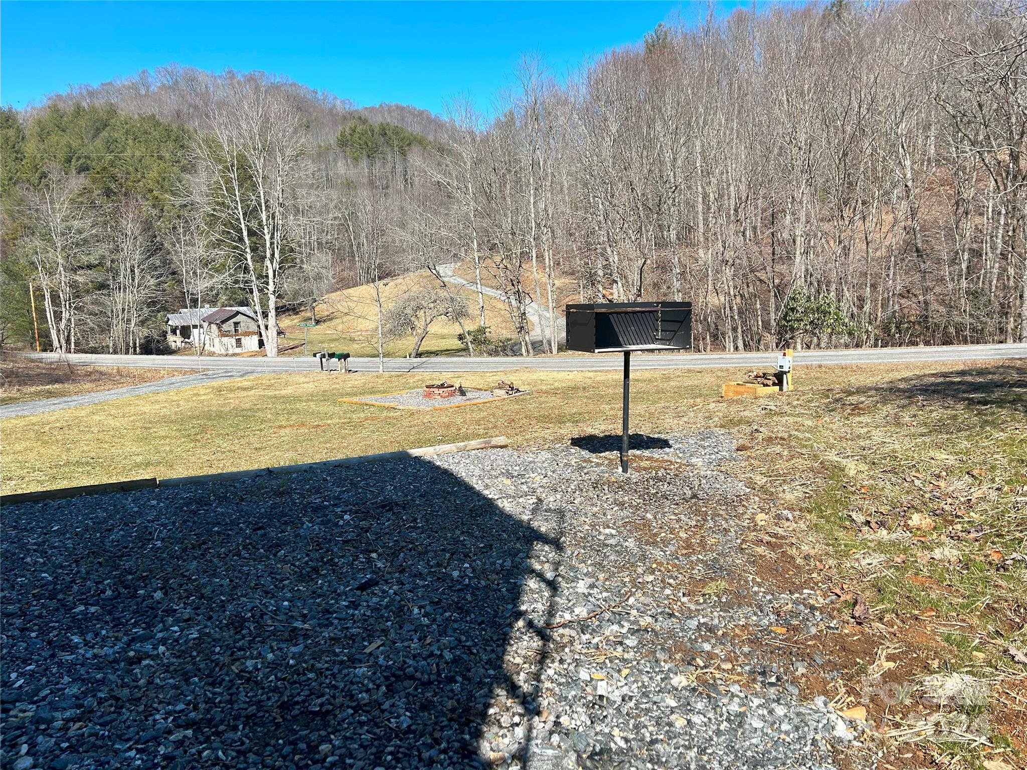 3280 Laurel Valley Road Mars Hill, NC 28754 - Photo 10 of 21 a view of a yard with an house and trees in the background