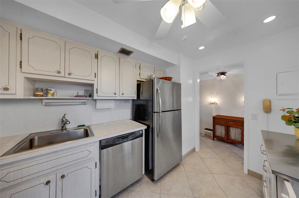 3000 North Palm Aire Drive, Unit 302 Pompano Beach, FL 33069 - Photo 2 of 23 a kitchen with white cabinets and refrigerator