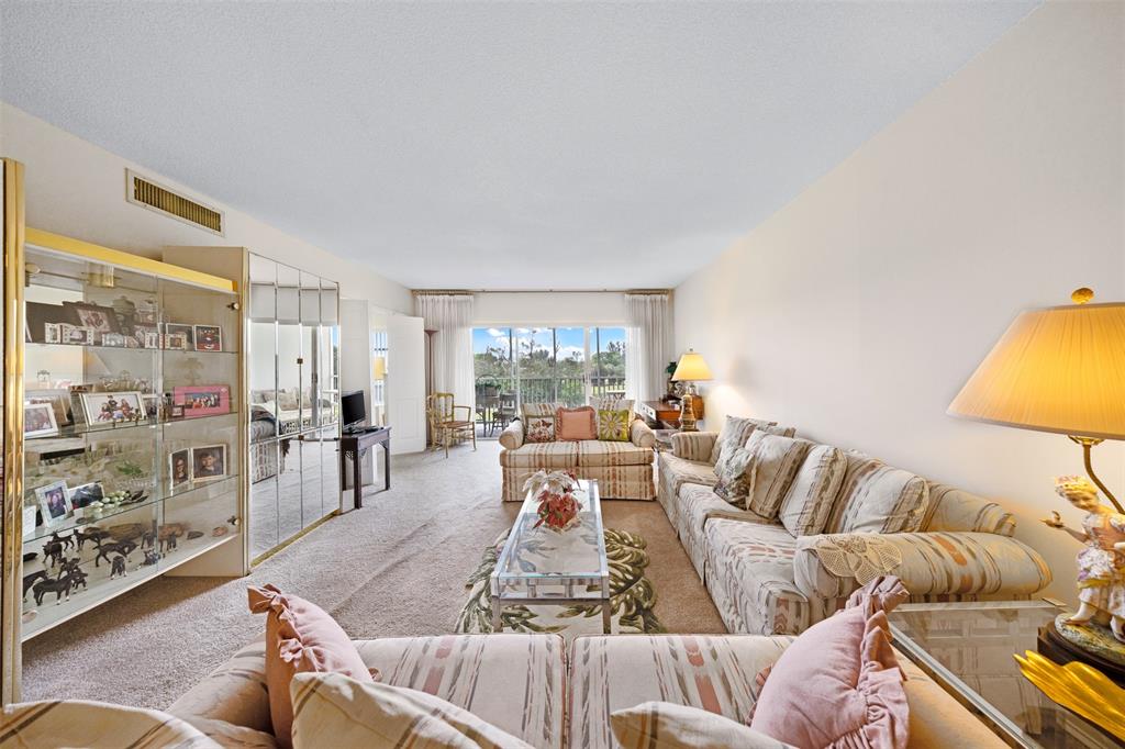 3000 North Palm Aire Drive, Unit 302 Pompano Beach, FL 33069 - Photo 5 of 23 a living room with furniture and a large window