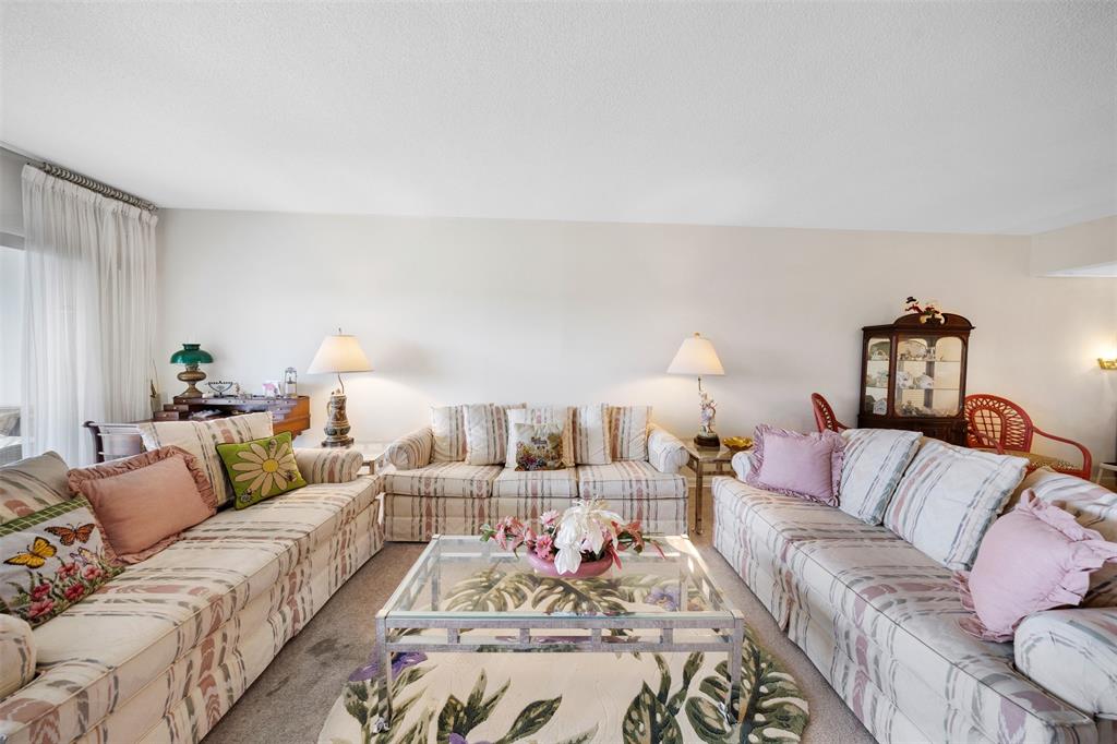 3000 North Palm Aire Drive, Unit 302 Pompano Beach, FL 33069 - Photo 7 of 23 a living room with furniture and a lamp