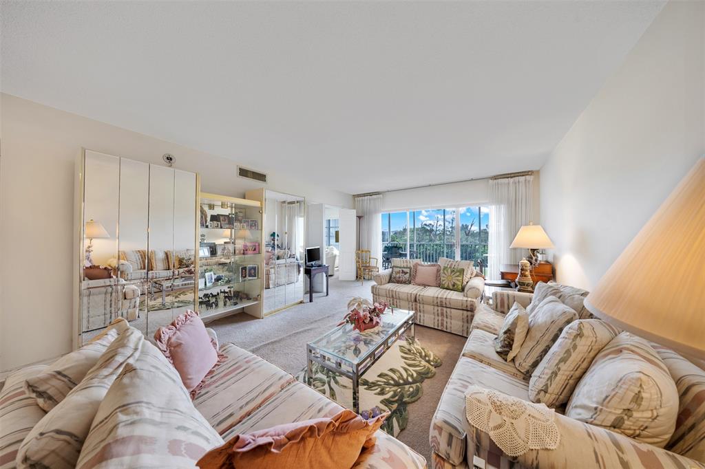 3000 North Palm Aire Drive, Unit 302 Pompano Beach, FL 33069 - Photo 8 of 23 a living room with furniture and a large window