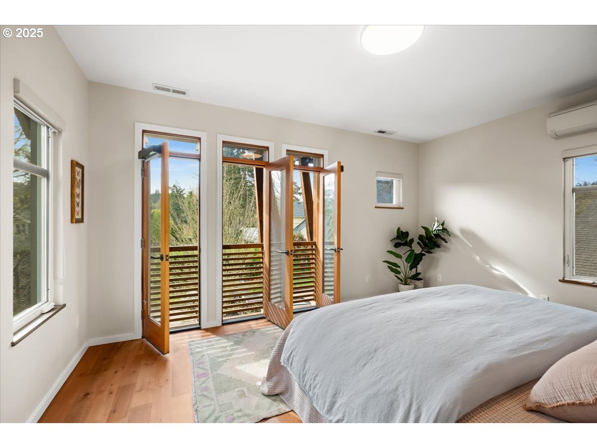 8316 Southeast 7th Avenue Portland, OR 97202 - Photo 15 of 44 a bedroom with a large bed and wooden floor