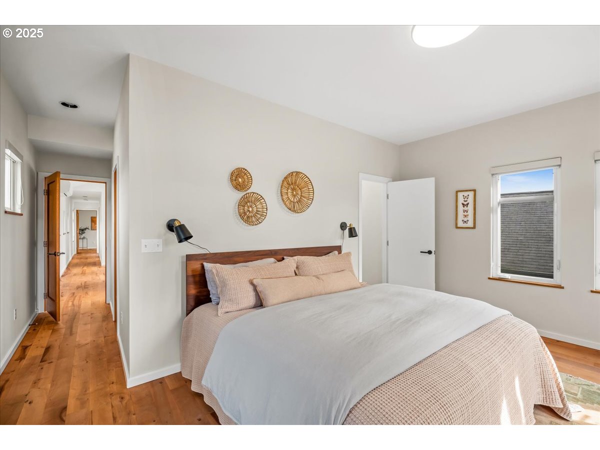 8316 Southeast 7th Avenue Portland, OR 97202 - Photo 17 of 44 a bedroom with a large bed and wooden floor