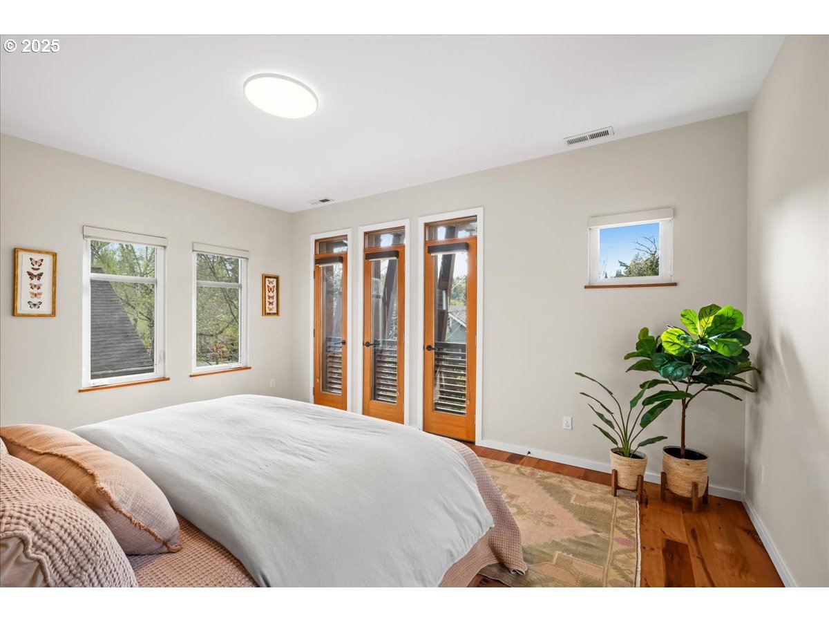 8316 Southeast 7th Avenue Portland, OR 97202 - Photo 18 of 44 a bedroom with a bed and a large window