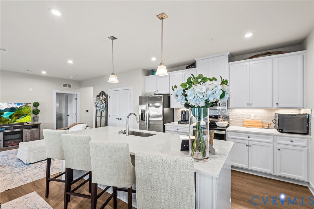 6655 Citory Way, Unit 103 Moseley, VA 23120 - Photo 13 of 48 a kitchen with sink and refrigerator