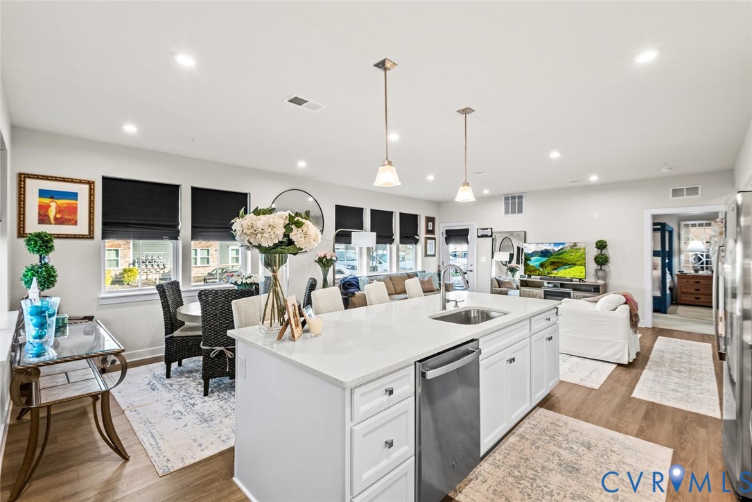 6655 Citory Way, Unit 103 Moseley, VA 23120 - Photo 48 of 48 a kitchen with stainless steel appliances kitchen island granite countertop a sink and cabinets
