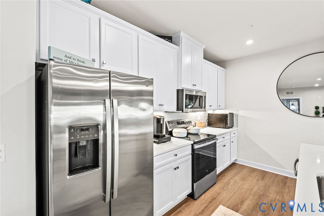 6655 Citory Way, Unit 103 Moseley, VA 23120 - Photo 14 of 48 a kitchen with stainless steel appliances a refrigerator sink and microwave