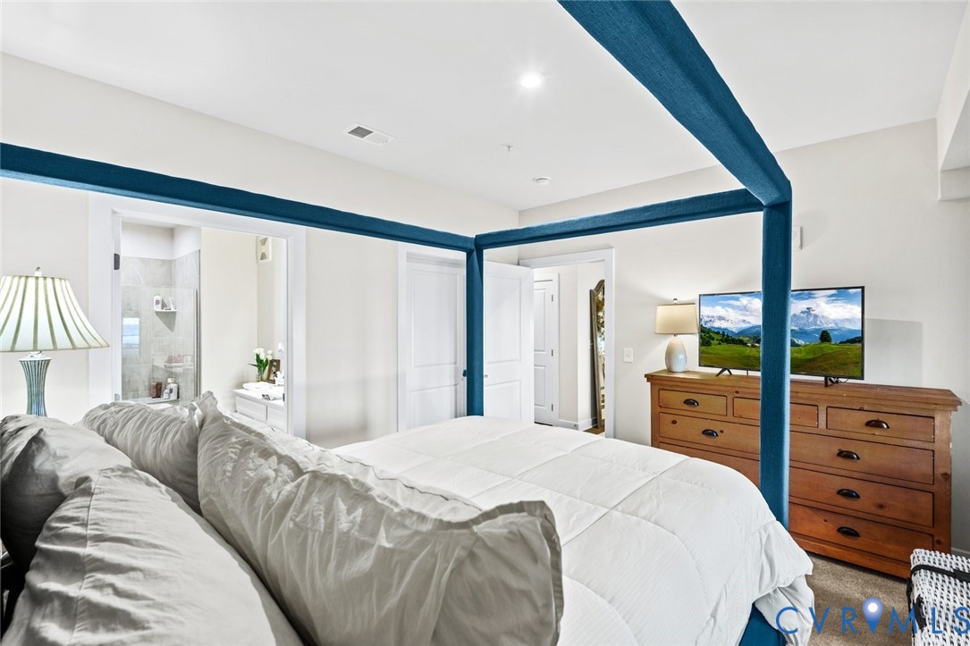 6655 Citory Way, Unit 103 Moseley, VA 23120 - Photo 17 of 48 a bedroom with a large bed and a window