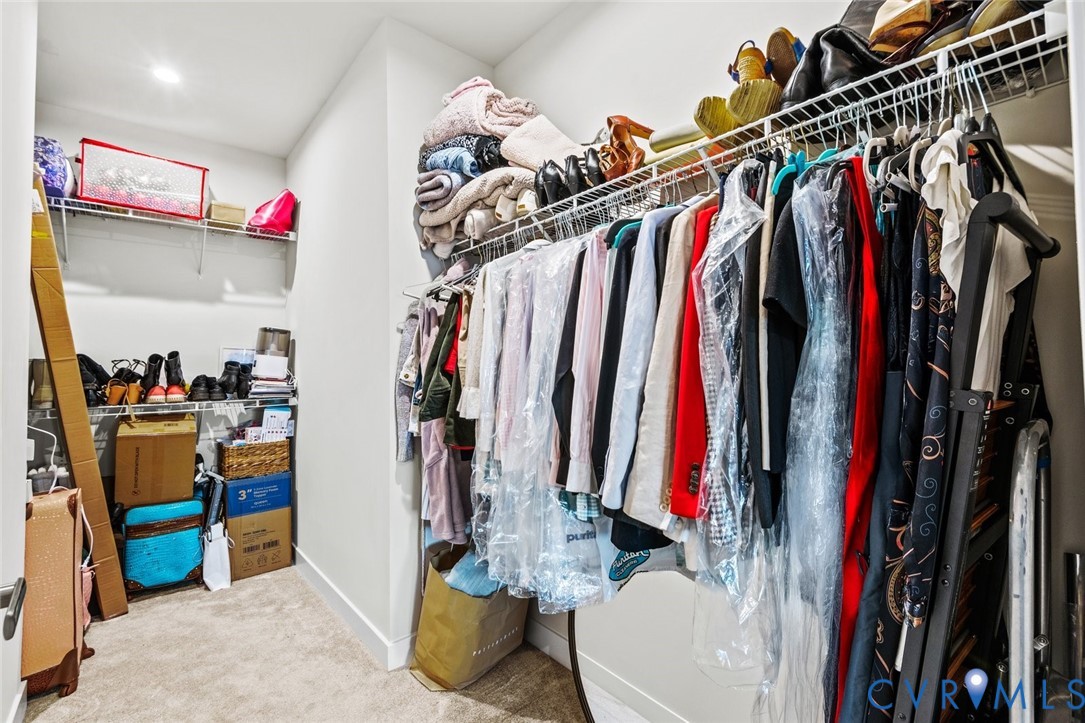 6655 Citory Way, Unit 103 Moseley, VA 23120 - Photo 19 of 48 a view of walk in closet with clothes and shoes