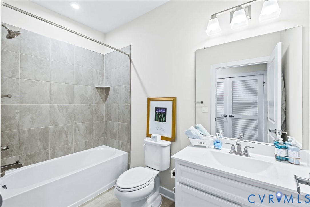 6655 Citory Way, Unit 103 Moseley, VA 23120 - Photo 22 of 48 a bathroom with a sink a toilet and shower