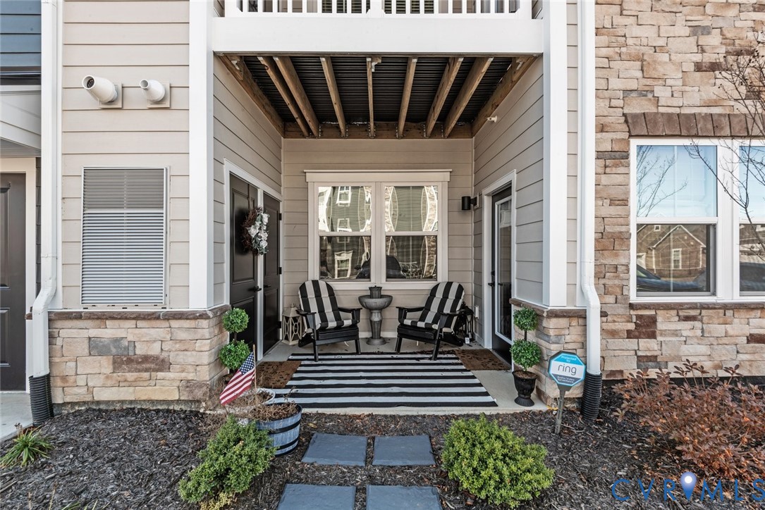 6655 Citory Way, Unit 103 Moseley, VA 23120 - Photo 26 of 48 a view of a patio with table and chairs and wooden floor