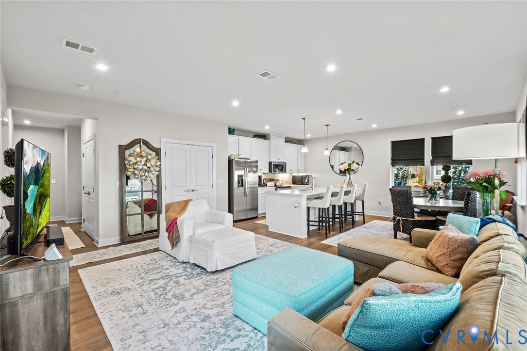 6655 Citory Way, Unit 103 Moseley, VA 23120 - Photo 9 of 48 a living room with furniture kitchen view and a wooden floor